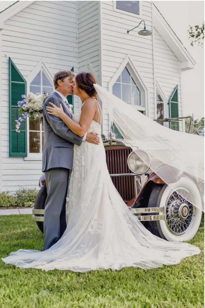 couple kissing in front of chapel